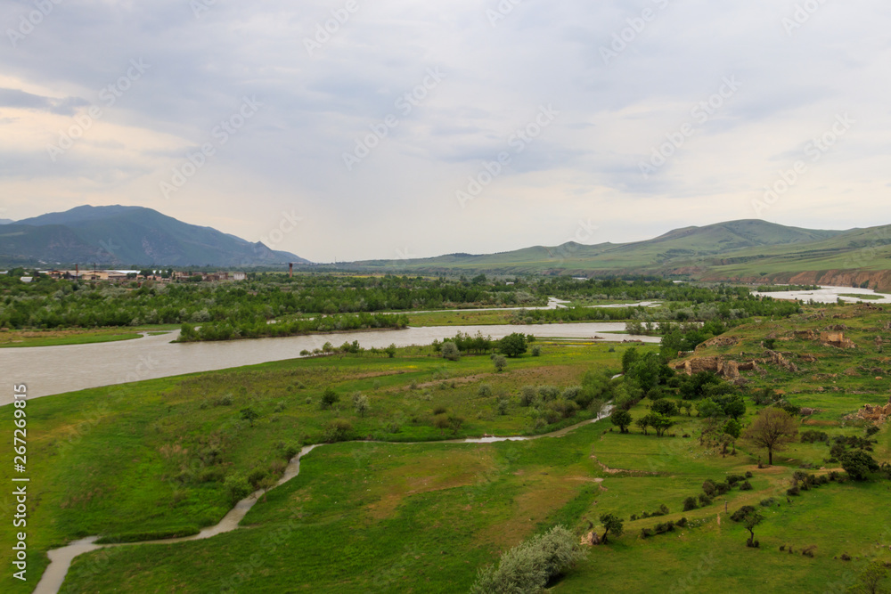 View on the Kura river and Caucasus mountains from Ancient cave city Uplistsikhe, Georgia View on the Kura river and Caucasus mountains from Ancient cave city Uplistsikhe, Georgia