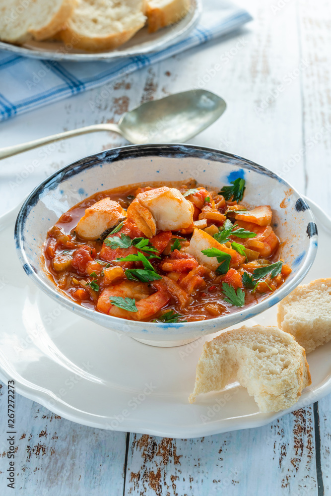 Tiger prawn and fish stew in a bowl