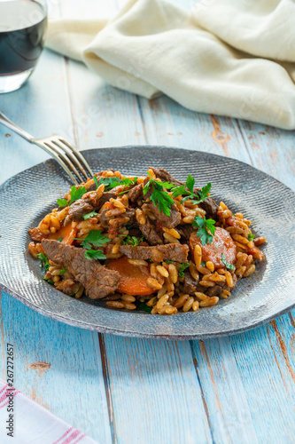 Giouvetsi - traditional Greek baked dish with beef and orzo pasta in tomato sauce.