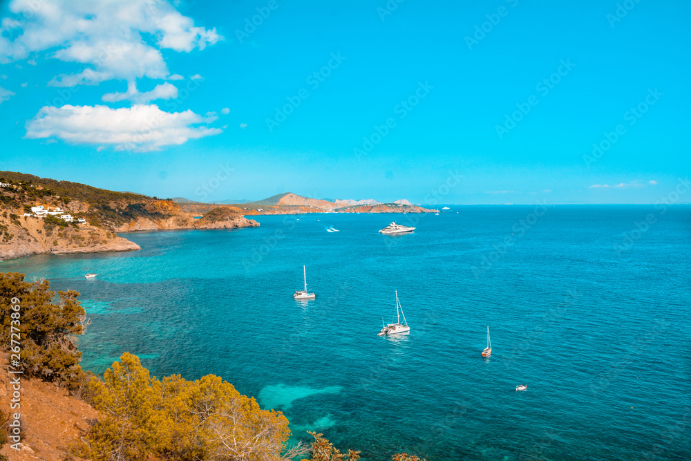 Beautiful ocean coastline in Ibiza island, part of Balearic archipelago in Spain. Orange and teal view