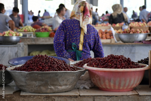 Woman selling cherries on Chorsu Bazaar in Tashkent, Uzbekistan
