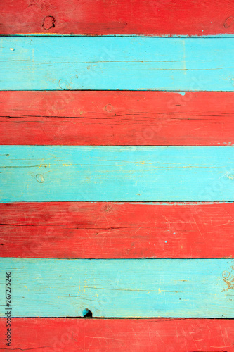 Red and blue wooden wall. The natural surface of painted wood.