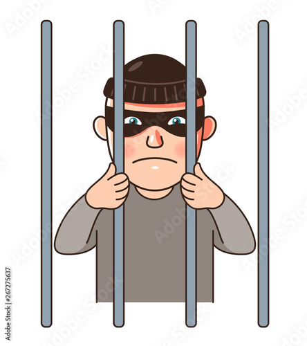 a male prisoner is imprisoned behind bars. 