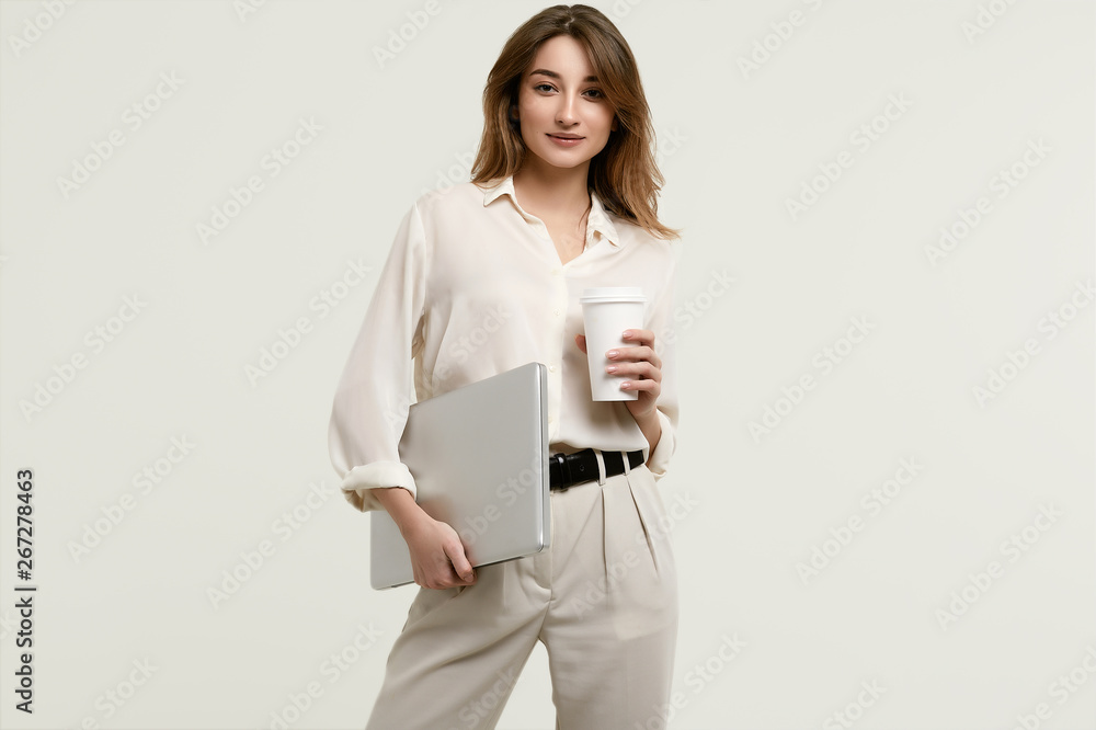 Gorgeous brunette model in white clothes with laptop and coffee Gorgeous brunette model in white clothes with laptop and coffee