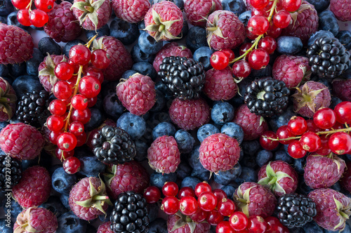 Ripe blackberries, blueberries, red currants and raspberries. Mix berries and fruits. Top view. Background berries and fruits. Various fresh summer fruits. Black-blue and pink food.