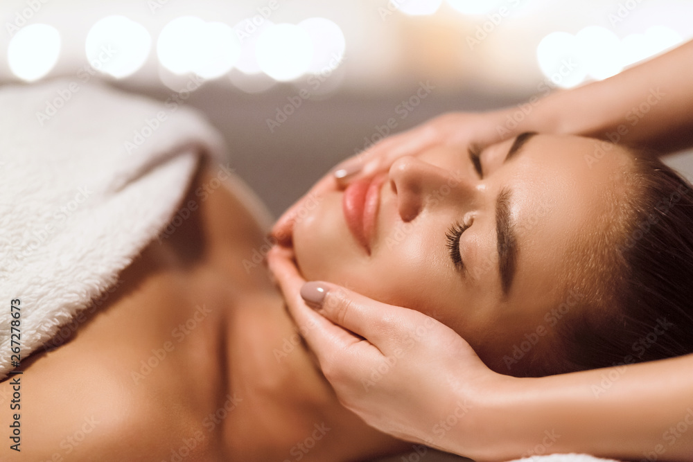 Facial Beauty Treatment. Woman Getting Face Massage