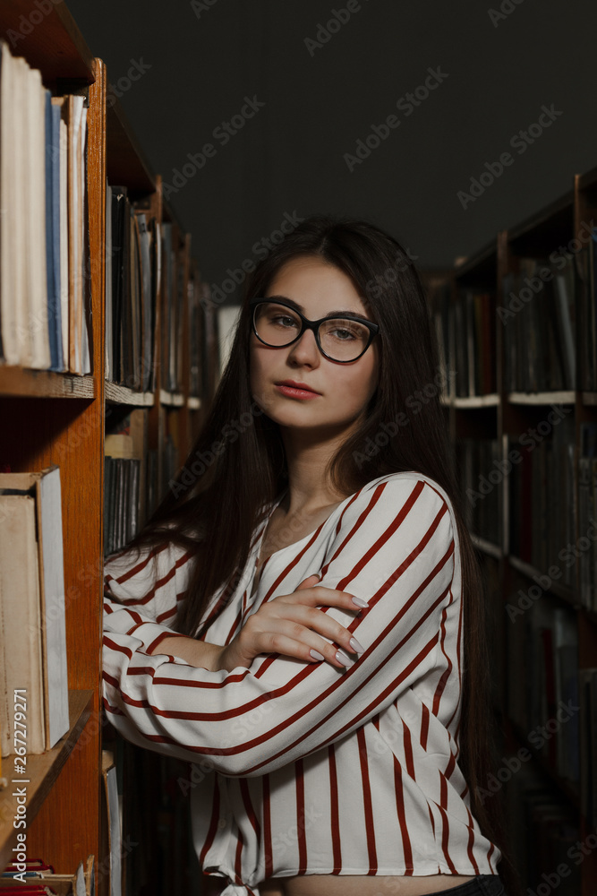 Young student girl in library. Education concept. Back to school Young student girl in library. Education concept. Back to school
