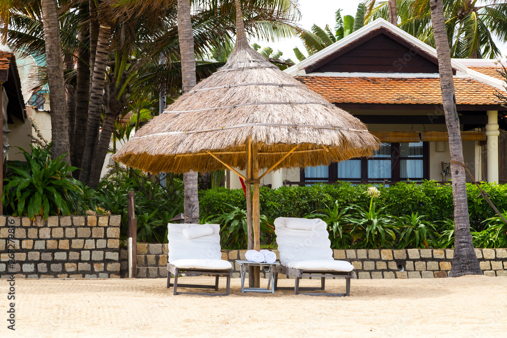 Deckchairs, umbrella and chair, parasol on the tropical sand beach