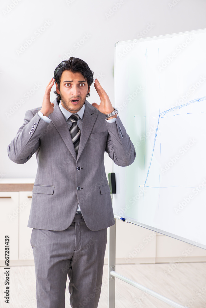 Young handsome businessman in front of whiteboard Young handsome businessman in front of whiteboard
