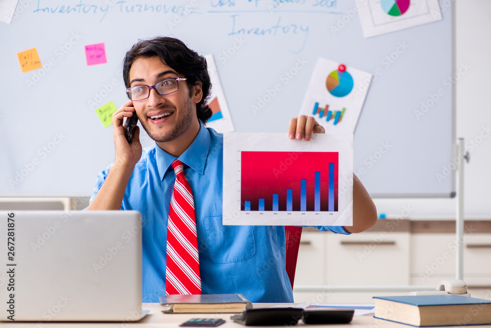 Young male financial manager working in the office Young male financial manager working in the office