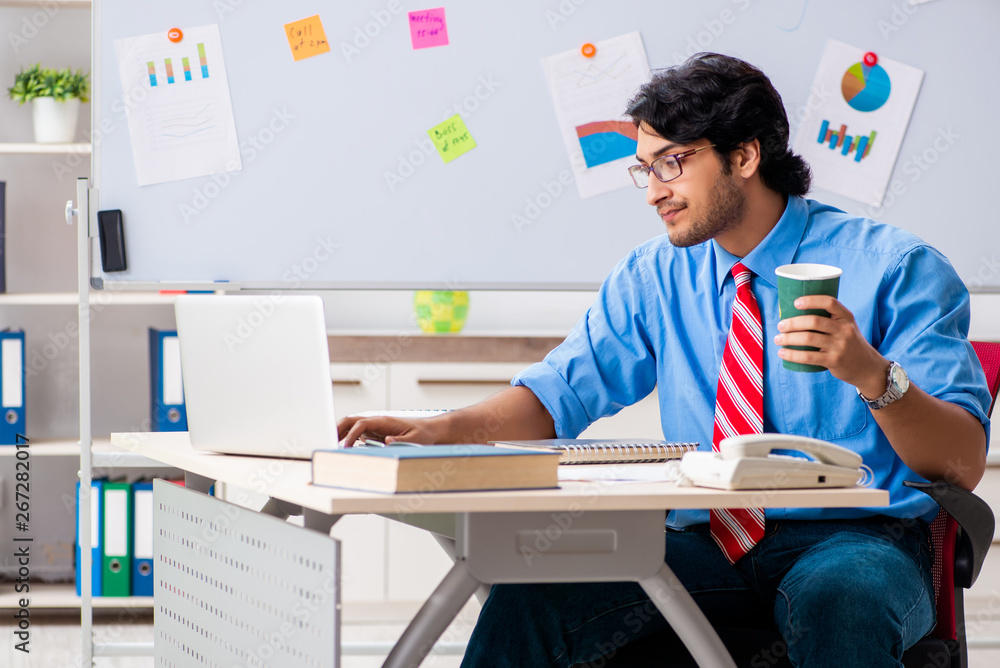 Young male financial manager working in the office Young male financial manager working in the office