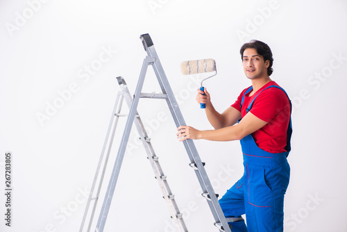 Young handsome contractor working indoors 