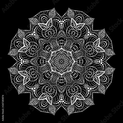 Round white crocheted lace doily. Decorative fractal mandala. Plant and wavy natural elements.