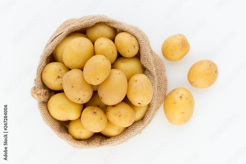 Sack of fresh raw potatoes on wooden background, top view Sack of fresh raw potatoes on wooden background, top view