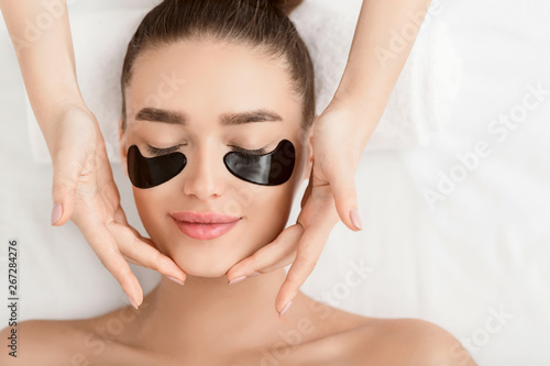 Face Massage. Woman With Black Eye Patches photo