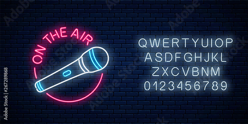 Neon on the air sign with microphone in round frame with alphabet. Nightclub with live music icon.