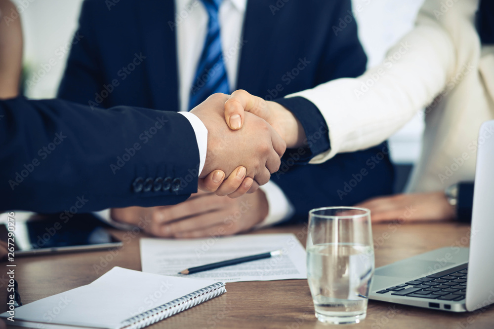 Business people shaking hands at meeting or negotiation in the office. Handshake concept. Partners are satisfied because signing contract Business people shaking hands at meeting or negotiation in the office. Handshake concept. Partners are satisfied because signing contract