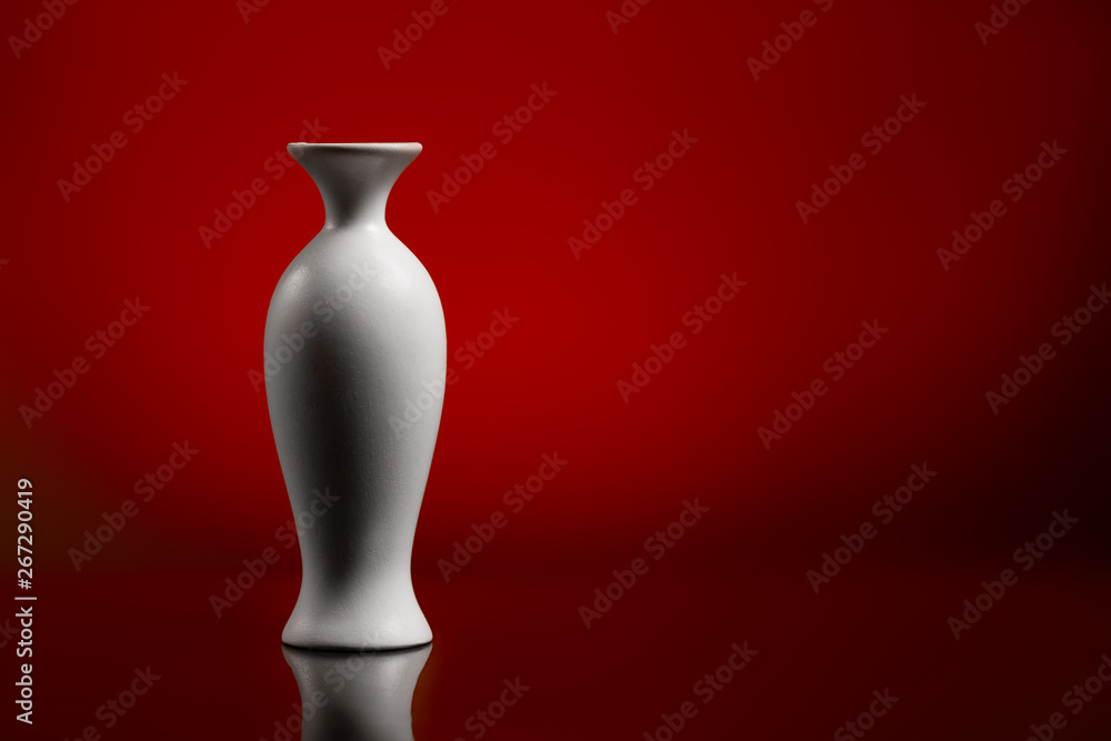 White vase on a blue background. Mirror surface White vase on a blue background. Mirror surface
