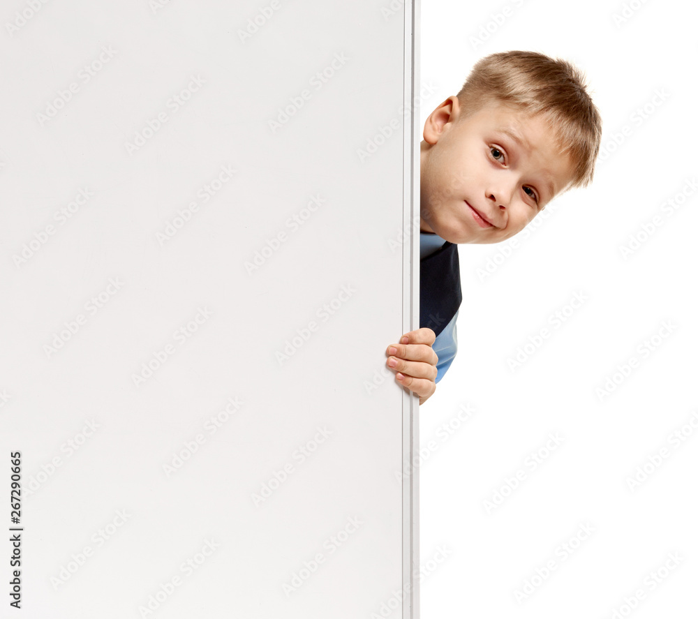 Portrait of young blond schoolboy posing behind whiteboard Portrait of young blond schoolboy posing behind whiteboard