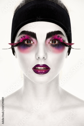 Portrait of young woman with feather eyelashes and bright makeup © Denys Kurbatov