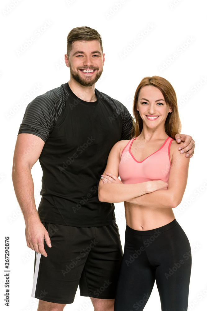 Fit bodybuilding couple posing together on white background Fit bodybuilding couple posing together on white background