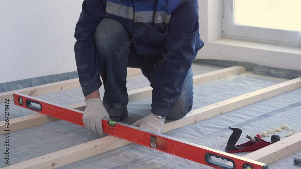 master carpenter mounts pine wood floor - eco-friendly flooring. screwing lag to concrete. master carpenter mounts pine wood floor - eco-friendly flooring. screwing lag to concrete.