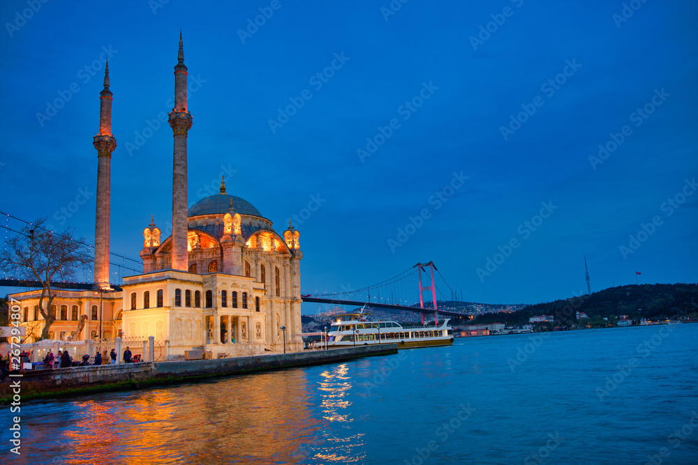 View of the Ortakoy Mosque in Istanbul City of Turkey. Historical Tower and sunset at Bosphorus.	