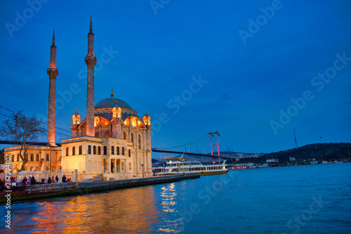 View of the Ortakoy Mosque in Istanbul City of Turkey. Historical Tower and sunset at Bosphorus. 