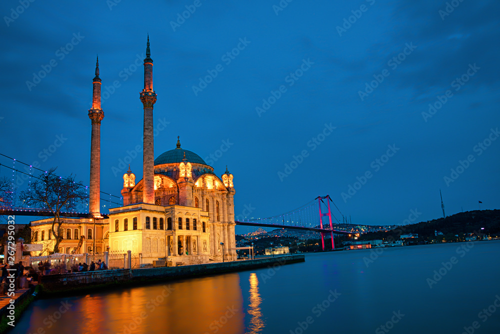 View of the Ortakoy Mosque in Istanbul City of Turkey. Historical Tower and sunset at Bosphorus.	