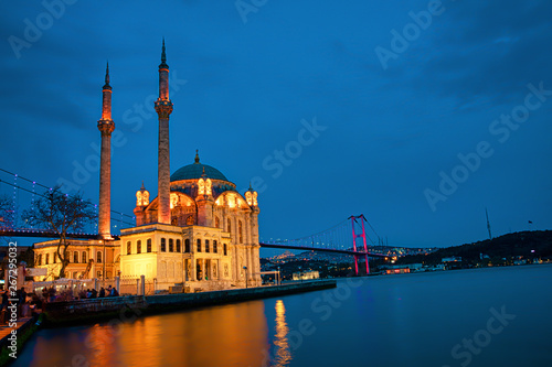 View of the Ortakoy Mosque in Istanbul City of Turkey. Historical Tower and sunset at Bosphorus. 