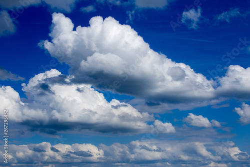 Obraz na plátně Regular spring clouds on blue sky at daylight in continental europe