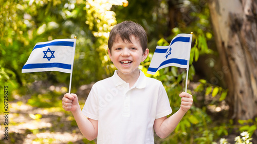 Israeli Happy Boy Hold and Waving Israeli Flag On Independence Day photo