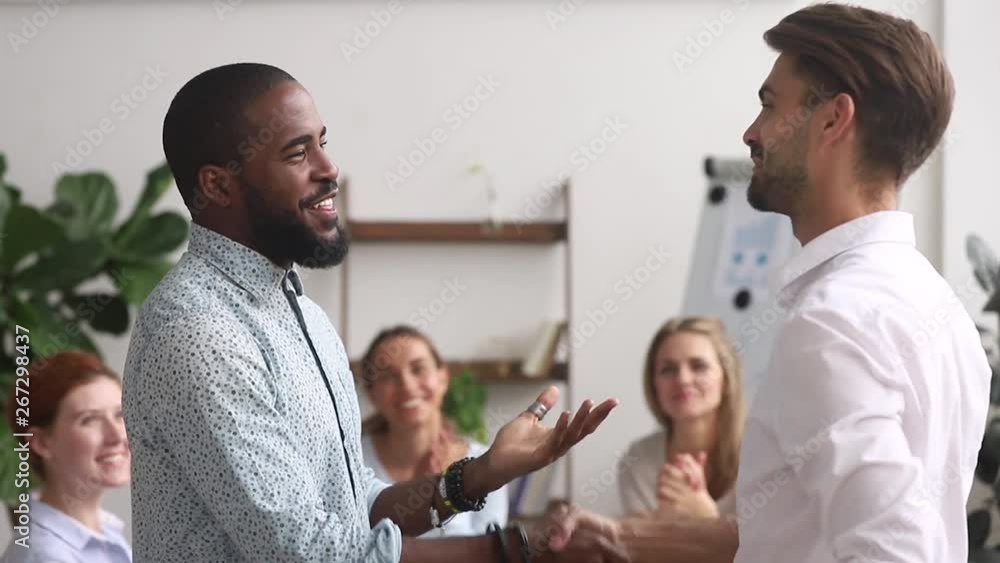Happy proud african american employee get rewarded promoted by manager Happy proud african american employee get rewarded promoted by manager