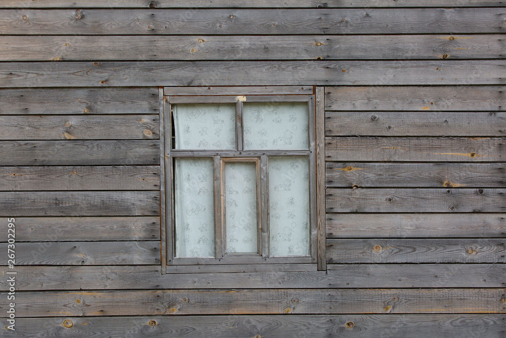 Fragment of one of walls of old village building with window. Fragment of one of walls of old village building with window.