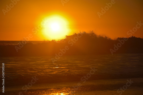 Orange sunset over the waves at Santa monica beach, California, USA