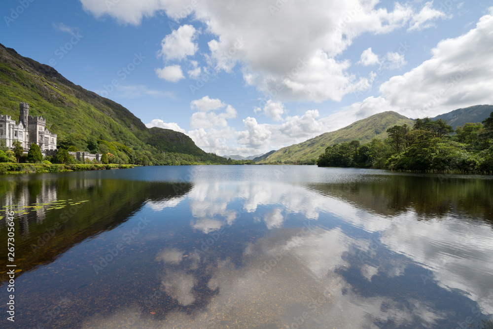 Kylemore Abbey in Connemara mountains and reflections in a beautiful lake, County Galway, Ireland