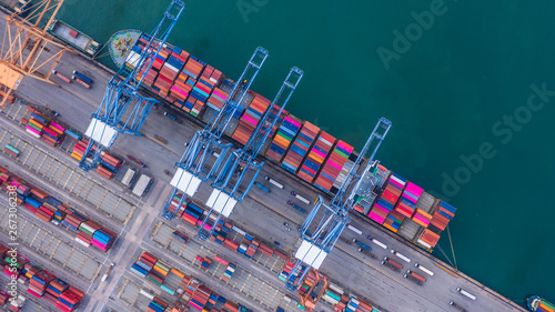 Container ship loading and unloading in deep sea port, Aerial top view of logistic import export transportation business by container ship in open sea.