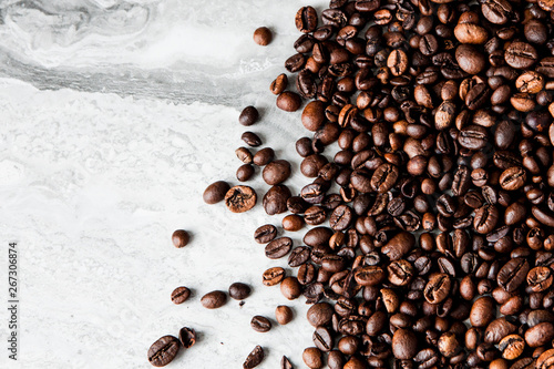 Coffee beans on marble background with copy space for text. Coffee background or texture concept
