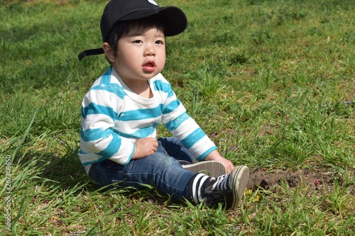 2 year old boy playing in the field