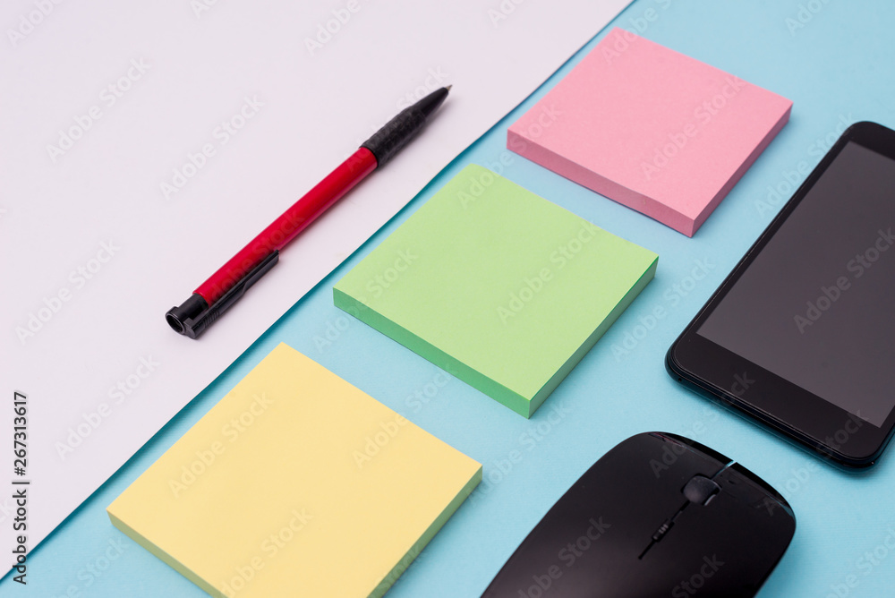 Note papers and stationary plus gadgets placed sideways above backdrop Design business concept Empty template copy space text for Ad website isolated Note papers and stationary plus gadgets placed sideways above backdrop Design business concept Empty template copy space text for Ad website isolated