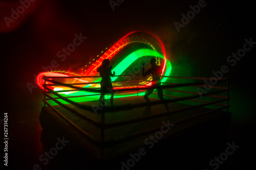 Man and woman boxing on the ring. Sport concept. Artwork decoration with foggy toned dark background.