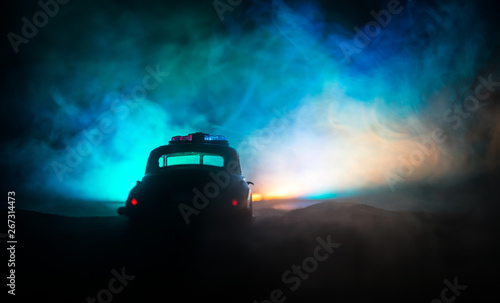 Police cars at night. Police car chasing a car at night with fog background. 911 Emergency response © zef art