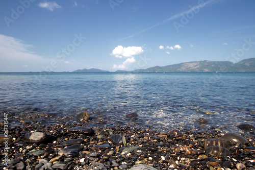 Idyllic crystal seawater in front of luxury hotel, attractive clear sea, nature coastline backgrounds during holidays, wave from clear blue green sea and fine sand