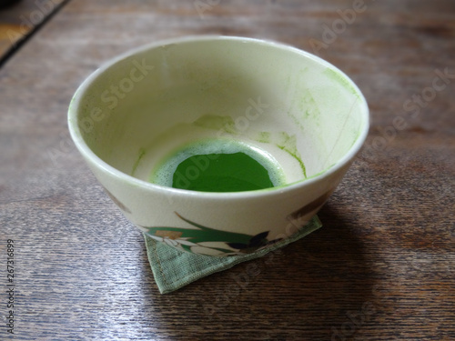 Close up picture of a cup of Matcha Tea on a wooden table