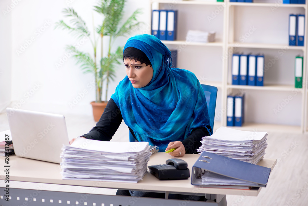 Female employee in hijab working in the office Female employee in hijab working in the office