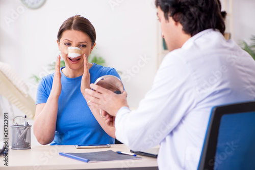 Woman visiting male doctor for plastic surgery  