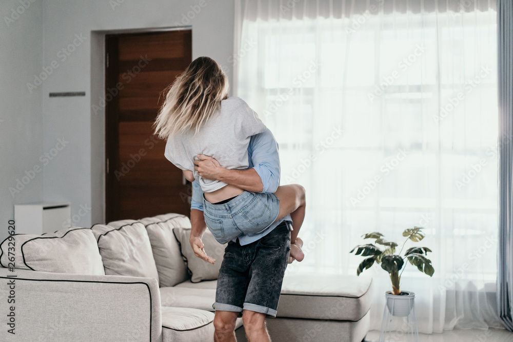Fototapeta premium young couple in love having fun and dancing enjoying their time together