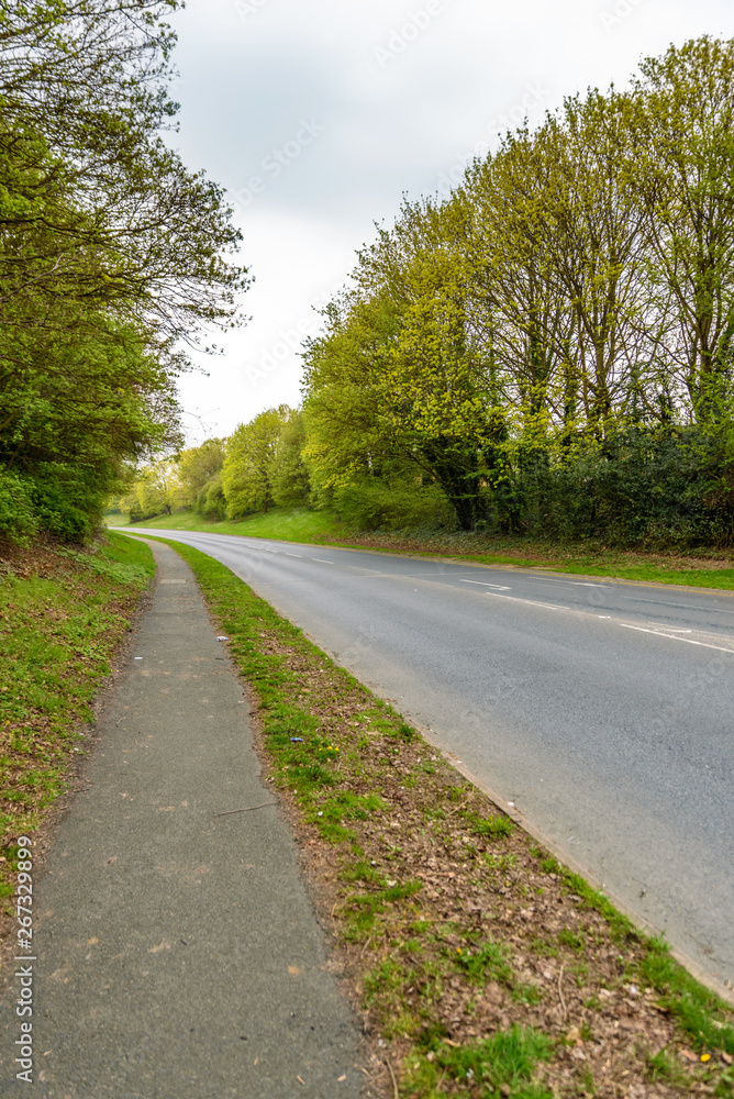 empty road and pedestrian footpath scene in england town