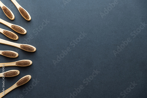 bamboo toothbrushes on dark rough background. plastic-free concept