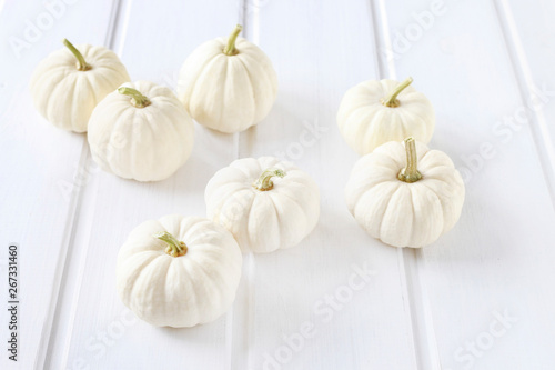 Baby boo pumpkins on white wooden table